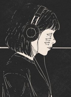 a woman with headphones on her ears looking down at something in front of her