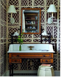 a bathroom with a sink, mirror and wooden cabinet in it's centerpiece