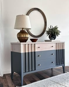 a dresser with two drawers and a lamp on top