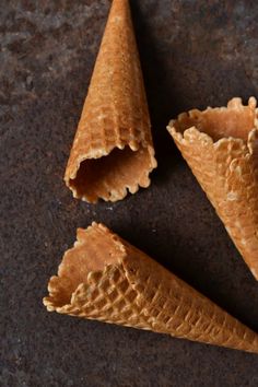 three cones of ice cream sitting on top of a table