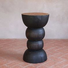 a wooden table sitting on top of a red tiled floor