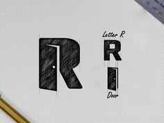 the letter r is drawn on top of a paper with a pencil next to it