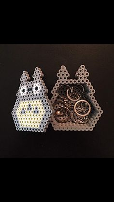 two pieces of bead art with rings in the shape of animals on black background