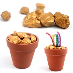 two clay pots filled with gold nuggets and some candy sticks next to them