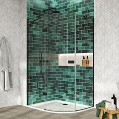 a green tiled bathroom with a walk in shower