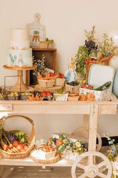 a table filled with lots of different types of food on top of wooden crates and baskets