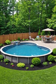 an above ground swimming pool surrounded by landscaping