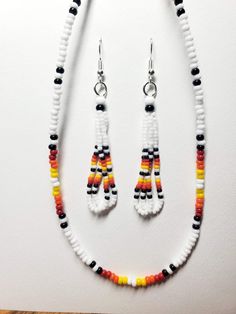 Native beaded Dangle White Fire earrings and Necklace. Necklace is 24 in with the expandable chain clasp. I use real Czech glass seed beads. All my items are handmade by me a proud Member of the Chippewa Tribe of Turtle Mountain. Beaded Earrings With Round Beads For Gifts, Handmade Heishi Bead Dangle Jewelry, White Czech Glass Beaded Dangle Earrings, Orange Jewelry With Tiny Beads For Crafting, Heishi Beads Jewelry With Dangling Beads As Gift, Adjustable Hand-strung Beaded Earrings, White Czech Glass Dangle Jewelry, Colorful Heishi Beads Dangle Jewelry, Adjustable White Beaded Earrings With Spacer Beads