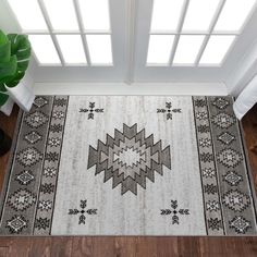 a large rug is shown in the middle of a room with wooden floors and windows