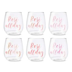 six wine glasses with pink and gold lettering