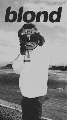 a man standing on top of a dirt road holding a cell phone to his ear