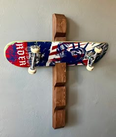 a skateboard mounted to the side of a wall with an american flag painted on it