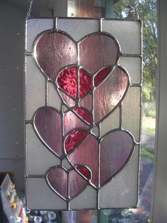 a stained glass window with hearts on it