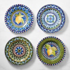 four plates with different designs on them