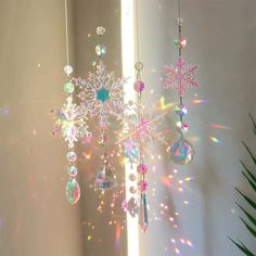 a snowflake hanging from the ceiling next to a mirror with lights on it