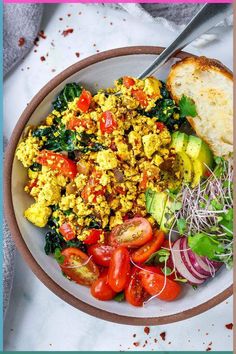 This Tofu Scramble is so delicious! Load it up with healthy seasonal veggies or keep it simple. A tasty vegan, high-protein breakfast in 15 minutes flat!