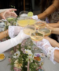 a group of people sitting around a table with drinks