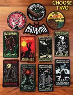 many different patches on a wooden surface with the words mothman written in black and white