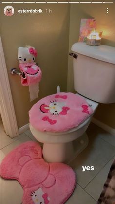 a bathroom with hello kitty rugs on the floor and a toilet in the corner