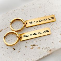 two gold keychains with the words ride or die est, 2013 on them