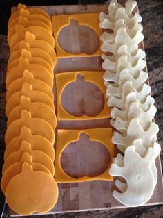 there are some cookies that have been cut into shapes to look like pumpkins and bones