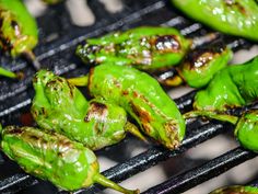 some green peppers are cooking on a grill