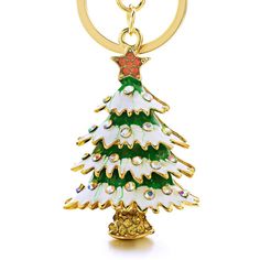 a christmas tree shaped keychain hanging from a gold ring on a white background