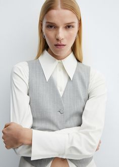 Pinstriped suit vest - Woman | MANGO USA Chic Striped V-neck Vest, Elegant Tailored Pinstripe Vest, Elegant Pinstripe Business Vest, Pinstripe Vest For Work, Vertical Stripes V-neck Tops For Workwear, Spring Workwear Vest With Vertical Stripes, Elegant Striped Vest For Spring, Tailored Pinstripe Vest For Spring, Pinstripe Sleeveless Tops For Work