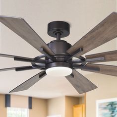 a ceiling fan with wooden blades in a living room