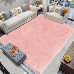 a living room filled with furniture and a pink rug