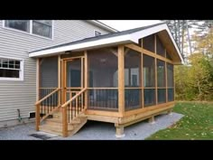 a screened porch in front of a house