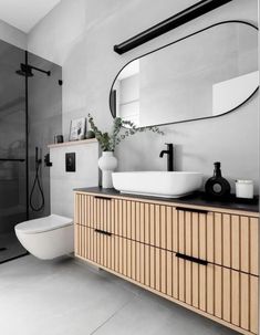 a bathroom with a sink, mirror and toilet in it's centerpieces