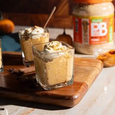 two desserts on a cutting board with peanut butter and whipped cream in the background