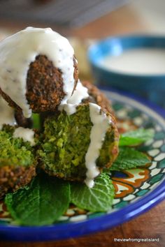 broccoli and meatballs with white sauce on a plate