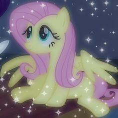 a pink pony laying on top of a wooden table next to a white knife and star filled sky