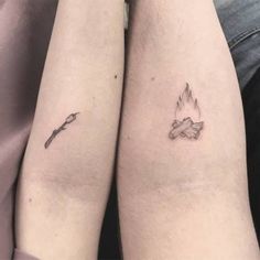 two people with tattoos on their legs holding each other's hands and one has a candle in it