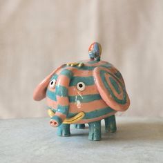 a ceramic elephant figurine sitting on top of a table