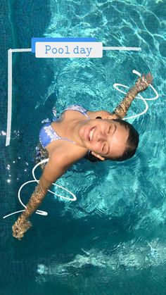 a woman is swimming in the pool with a frisbee and water hoses