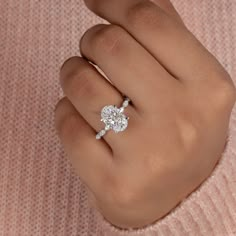 a woman's hand with a diamond ring on it