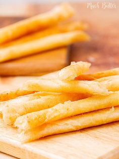 some french fries are on a cutting board