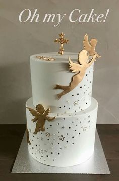 there is a white cake with gold decorations on the top and bottom layer that says oh my cake