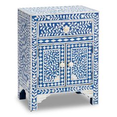 an ornate blue and white cabinet with drawers on one side, decorated with flowers and leaves