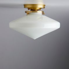 a white light hanging from a ceiling fixture