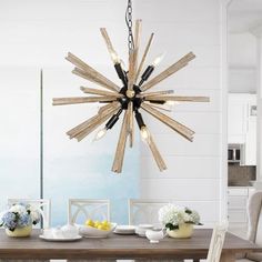 a dining room table with chairs and a chandelier hanging from it's ceiling