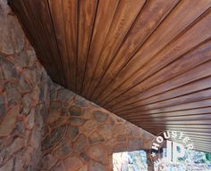 the inside of a house with wood and stone walls