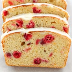 slices of pound cake with white icing and raspberry toppings on top