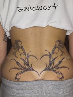 the back of a woman with tattoos on her stomach