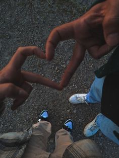 two people making a heart with their hands