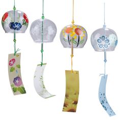 four hanging glass ornaments with flowers on them