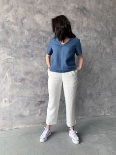 "Handmade washed linen top with short sleeves. Made with love for You. *100% local medium weight linen *Washed eco-friendly linen *Each item is individually cut and sewn by order *The model is wearing size L, blouse color - Blue *Note that colors may look different on your display depending on their settings and technical characteristics. Please let us know if you need different measurements or colors. CARE *Machine wash up to 40 / 104F gentle cycle *Iron inside out at medium high *Do not bleach Short Top And Pant, Tunics Outfits For Women, Blue Linen V-neck Blouse, Casual V-neck Tops In Ramie, Casual V-neck Ramie Top, Casual Short Sleeve Ramie Tops, Casual Linen Short Sleeve Tops, Casual Short Sleeve Linen Tops, Casual Linen Blouse In Flax Color